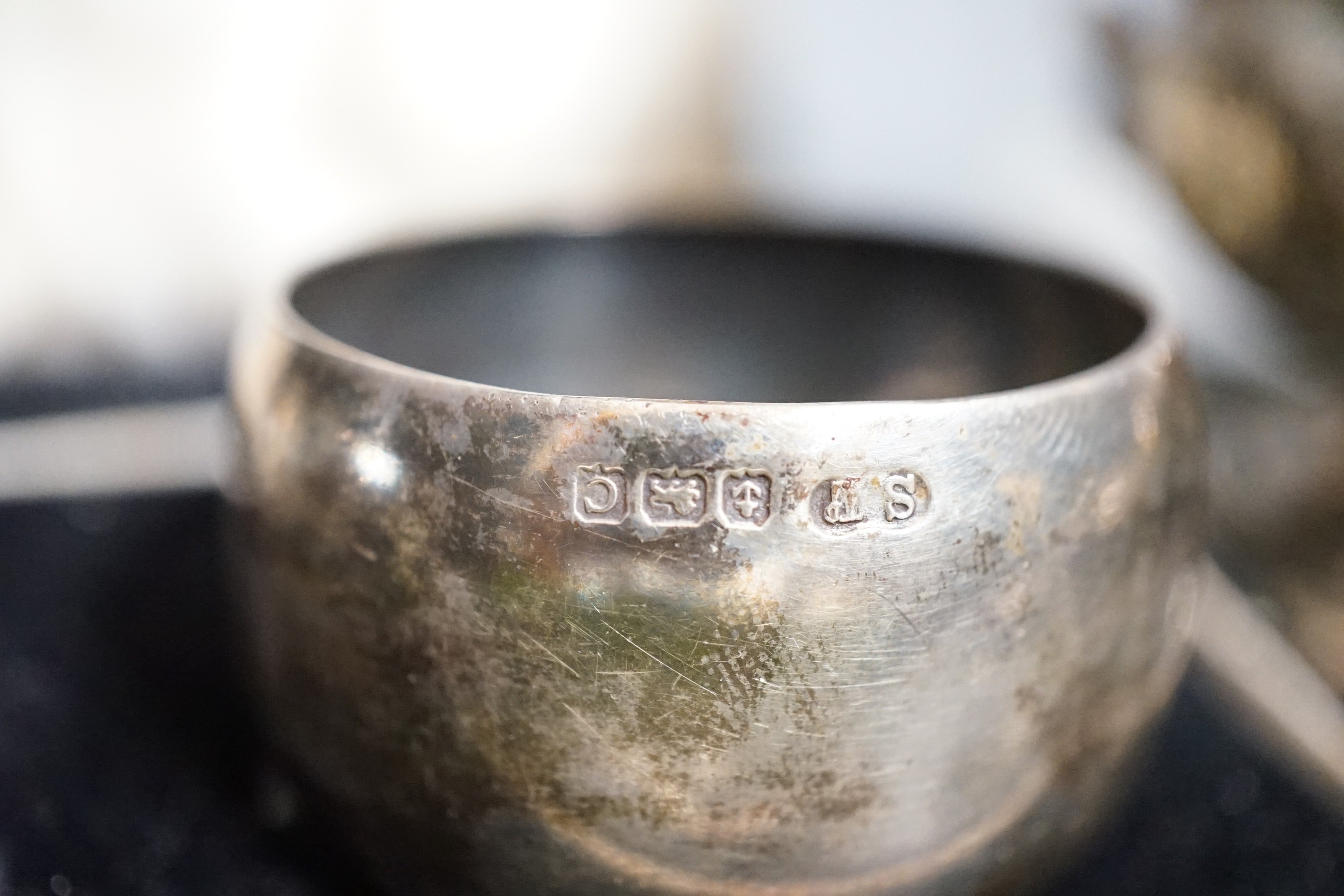 A Victorian repousse silver christening mug, Birmingham, 1861, 9.5cm, a cased pair of silver napkin rings, four assorted silver mounted toilet jars, a silver compact, small silver trophy cup and a silver caddy spoon.